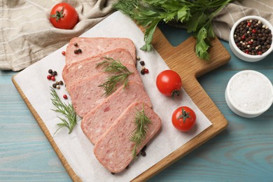 Photo of Pieces of tasty canned meat, dill, spices and tomatoes on light blue wooden table, flat lay