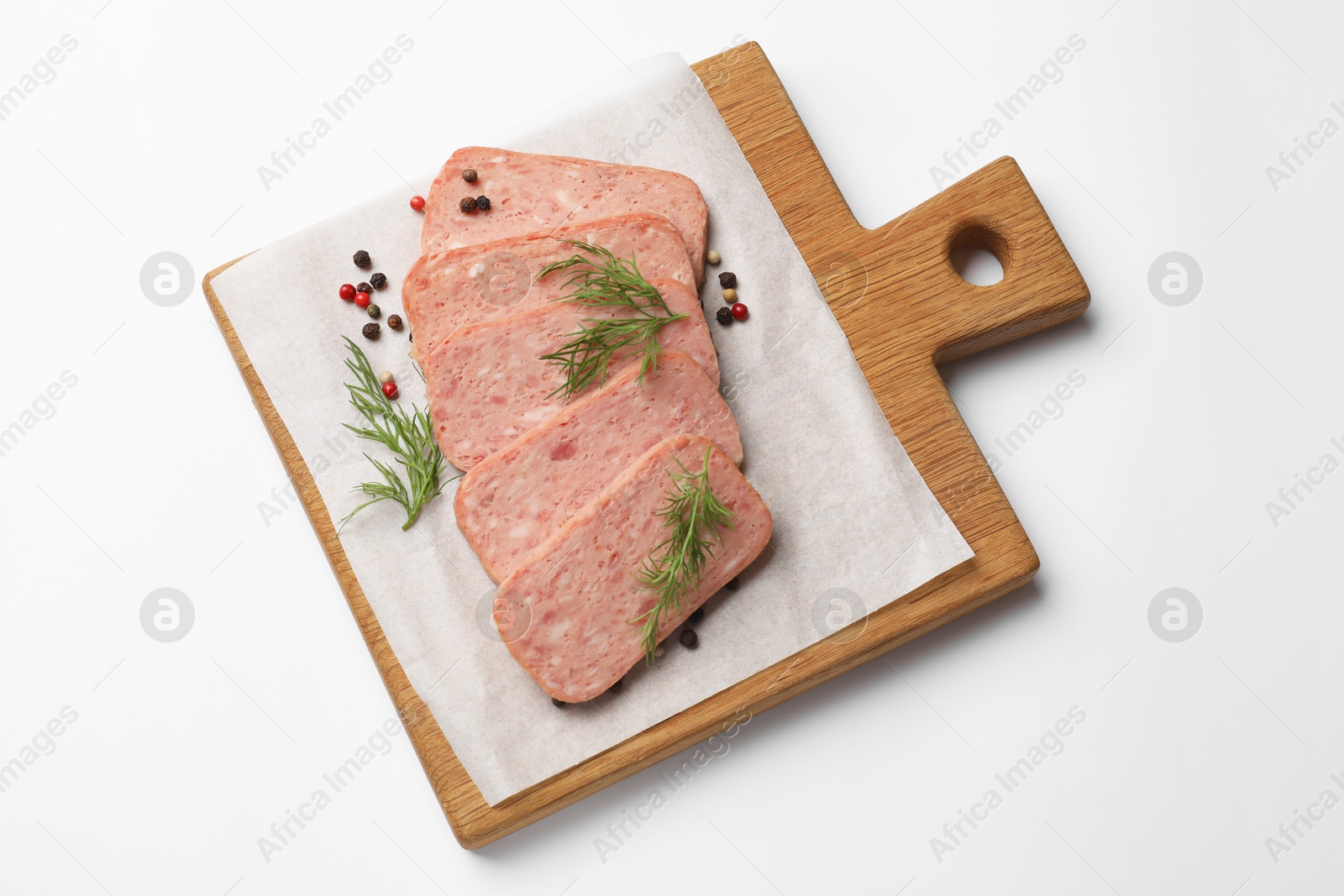 Photo of Pieces of tasty canned meat, dill and peppercorns on white background, top view