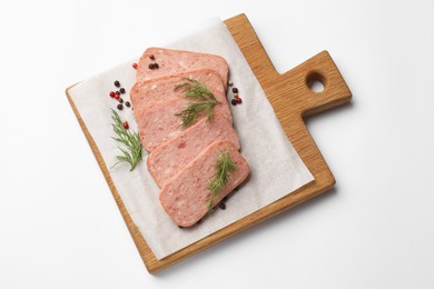 Photo of Pieces of tasty canned meat, dill and peppercorns on white background, top view