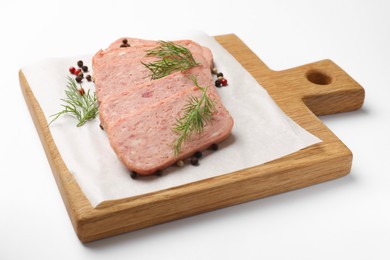 Photo of Pieces of tasty canned meat, dill and peppercorns on white background