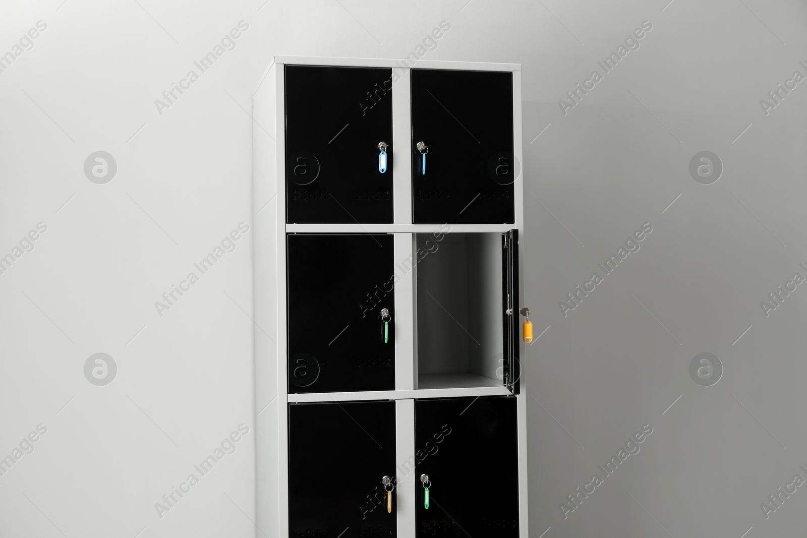 Photo of Open lockers with keys on light background