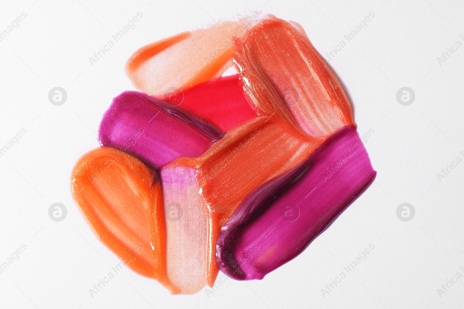 Photo of Samples of different lipglosses on light grey background, top view