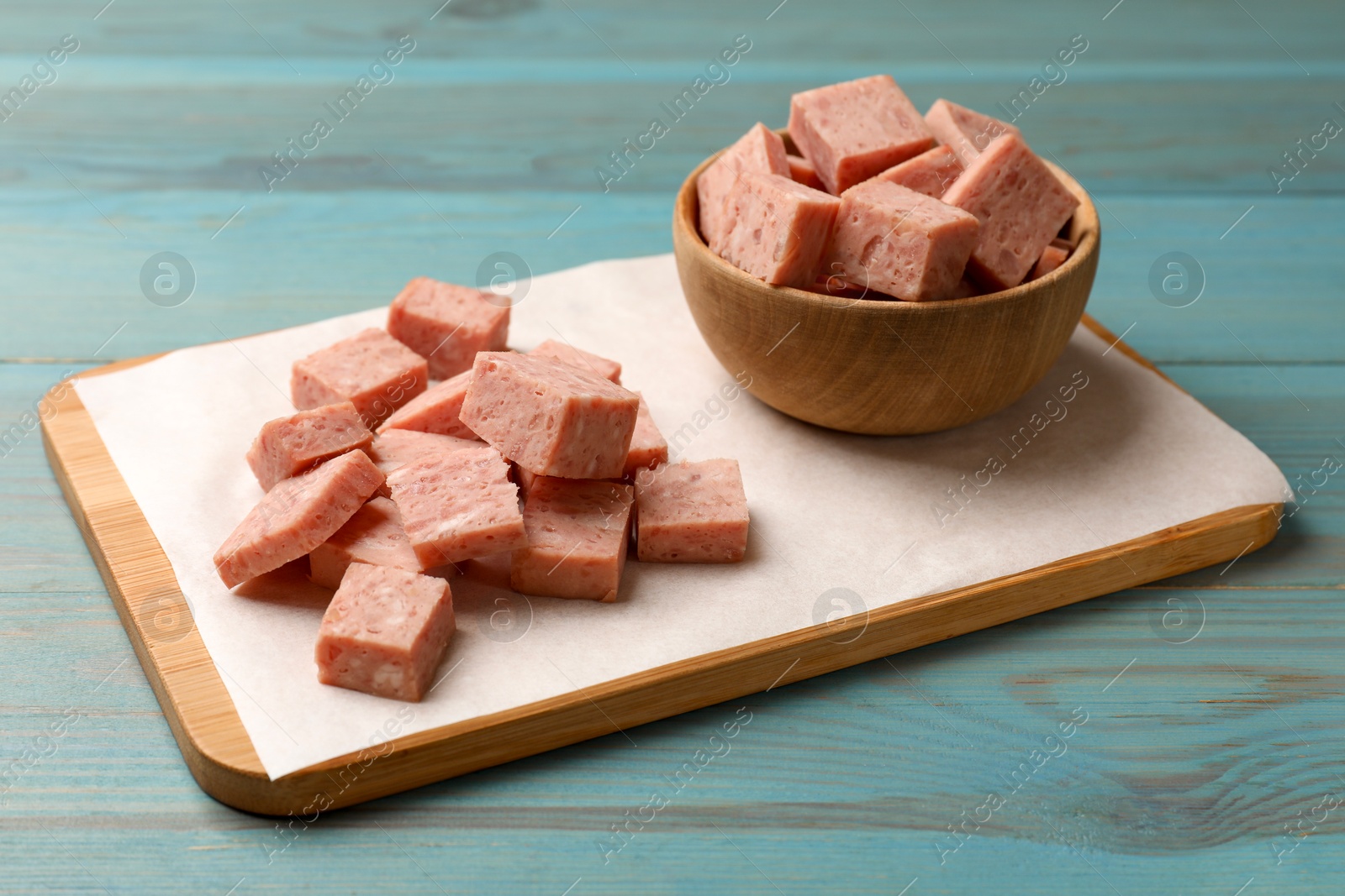 Photo of Pieces of canned meat on blue wooden table