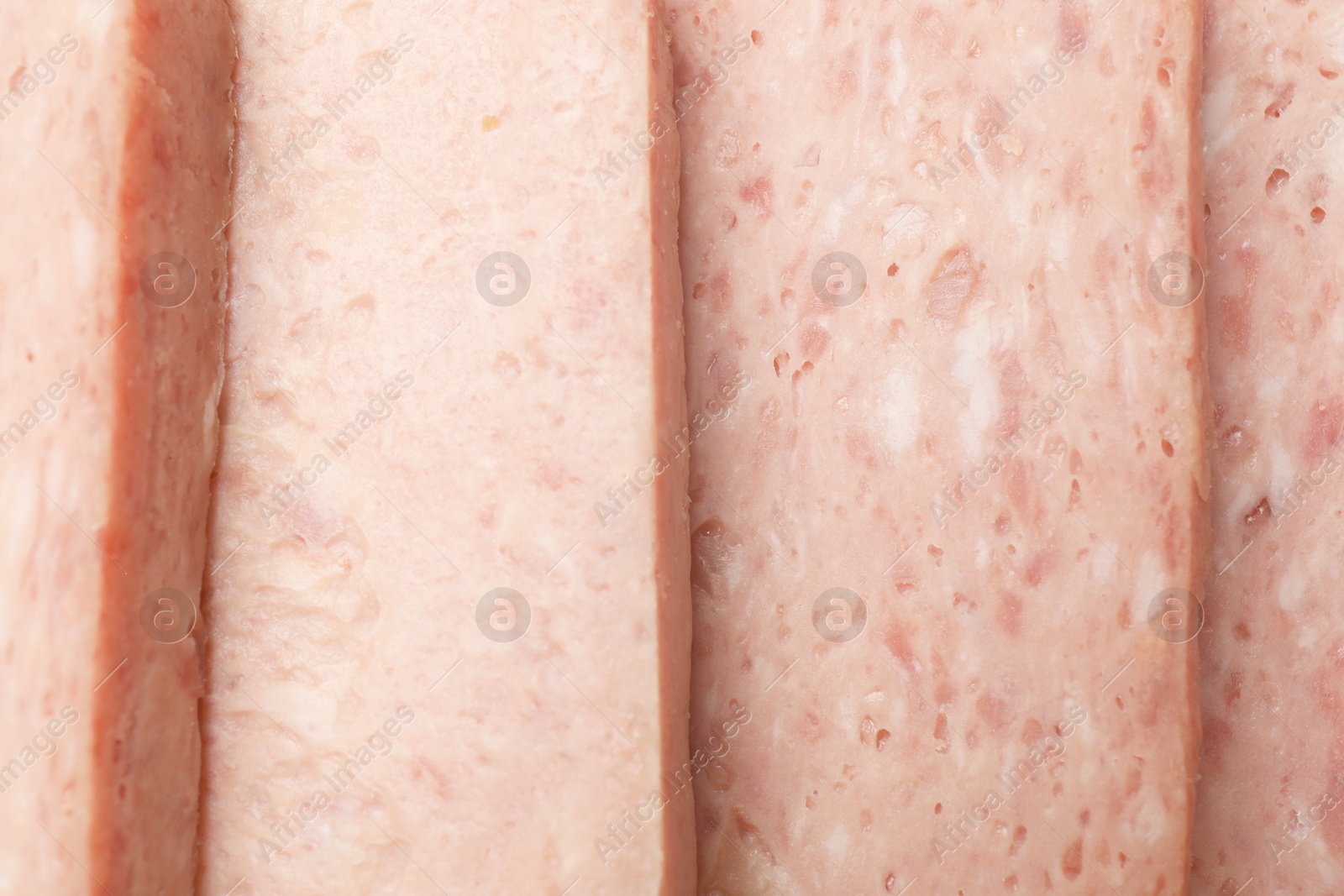 Photo of Pieces of canned meat as background, closeup