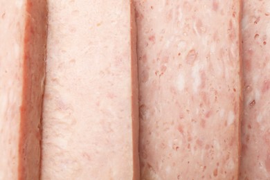 Photo of Pieces of canned meat as background, closeup