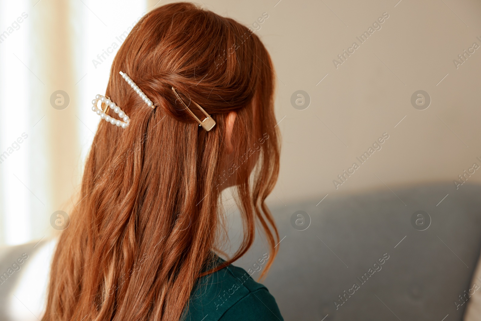 Photo of Teenage girl with stylish hair clips indoors, back view. Space for text