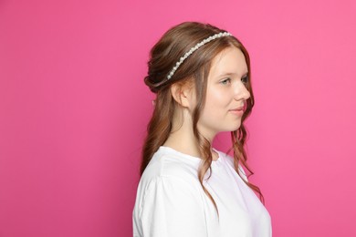 Photo of Teenage girl with stylish hair accessory on pink background