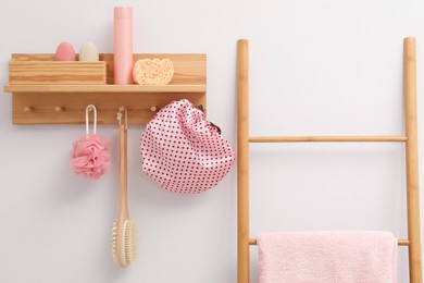 Photo of Shower cap and bath accessories in bathroom