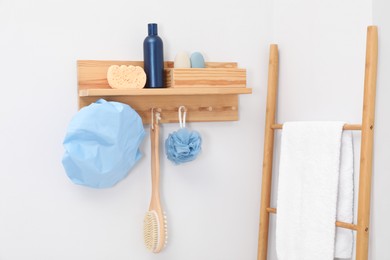 Photo of Shower cap and bath accessories on rack indoors