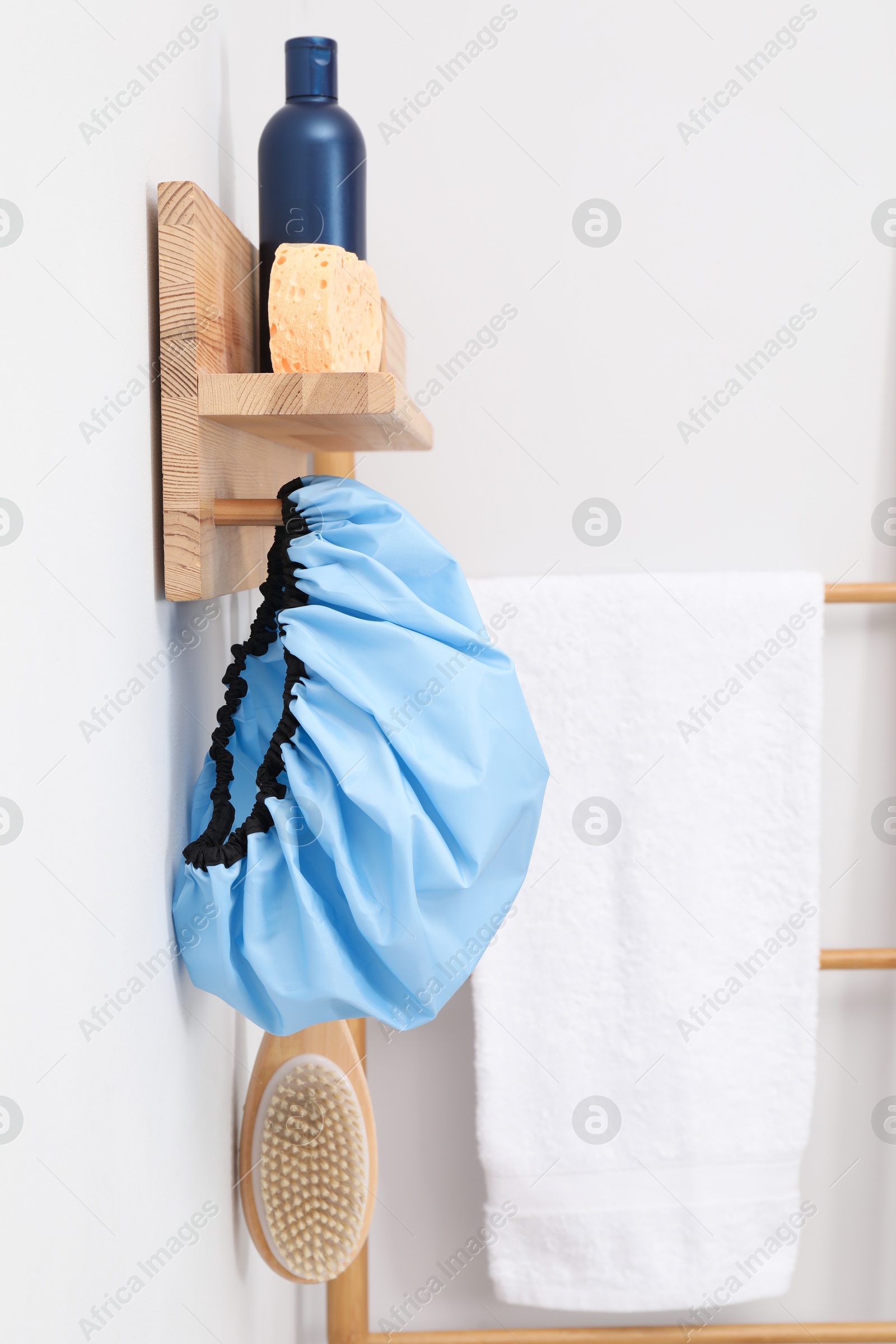 Photo of Shower cap and bath accessories on rack indoors