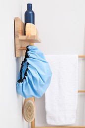 Photo of Shower cap and bath accessories on rack indoors