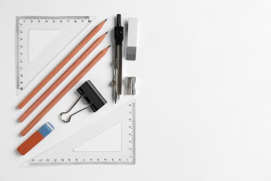 Photo of Flat lay composition with ruler and other stationery on white background, space for text