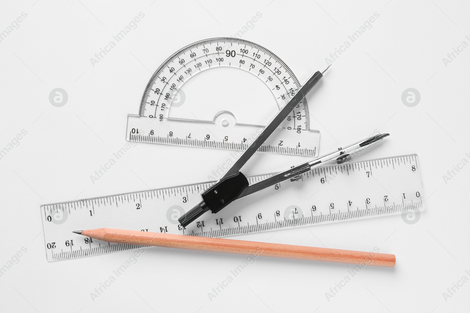 Photo of Rulers, pencil and compass on white background, flat lay