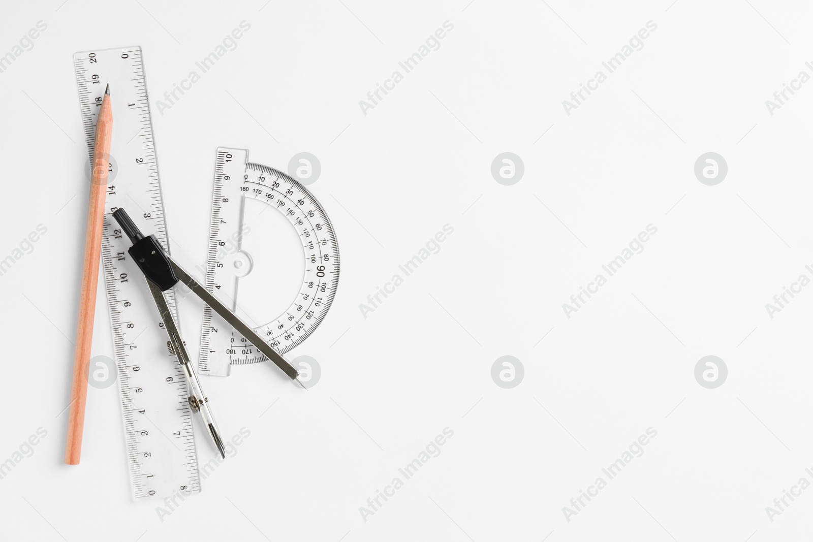 Photo of Rulers, pencil and compass on white background, flat lay. Space for text