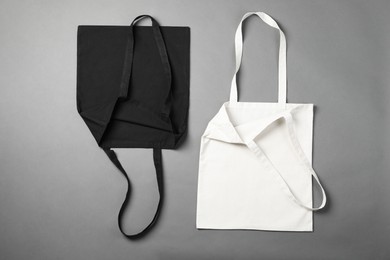 Photo of Shopping bags on grey background, flat lay. Mockup for design