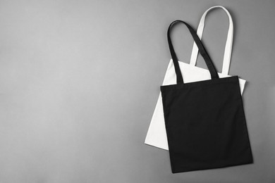 Photo of Shopping bags and space for text on grey background, top view. Mockup for design