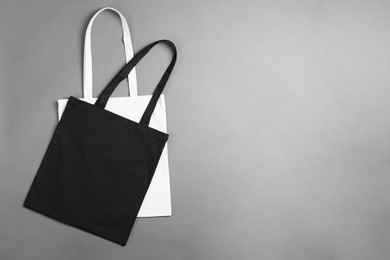 Photo of Shopping bags and space for text on grey background, top view. Mockup for design