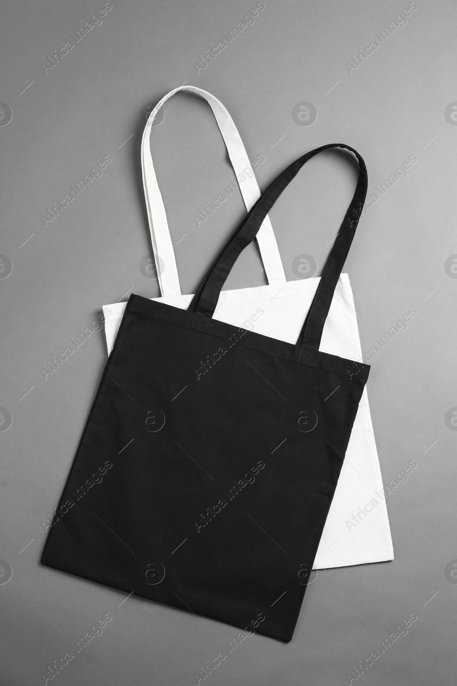 Photo of Shopping bags on grey background, top view. Mockup for design