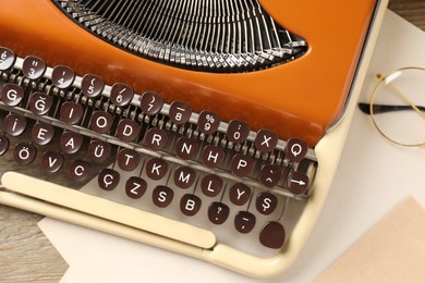 Photo of Vintage typewriter and paper sheets on table, closeup