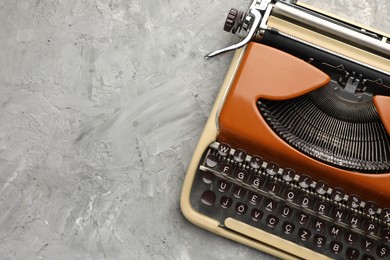 Photo of Vintage typewriter on grey background, top view. Space for text