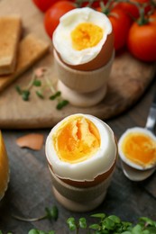 Photo of Soft boiled eggs on wooden table, closeup