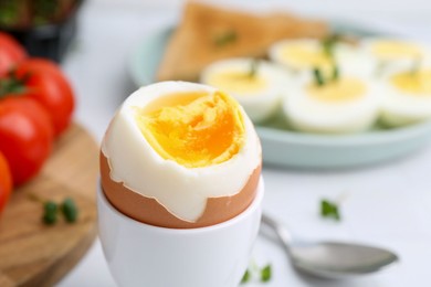 Photo of Soft boiled egg on white table, closeup