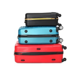 Photo of Stack of colorful suitcases isolated on white