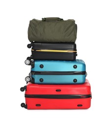 Photo of Stack of colorful suitcases and bag isolated on white