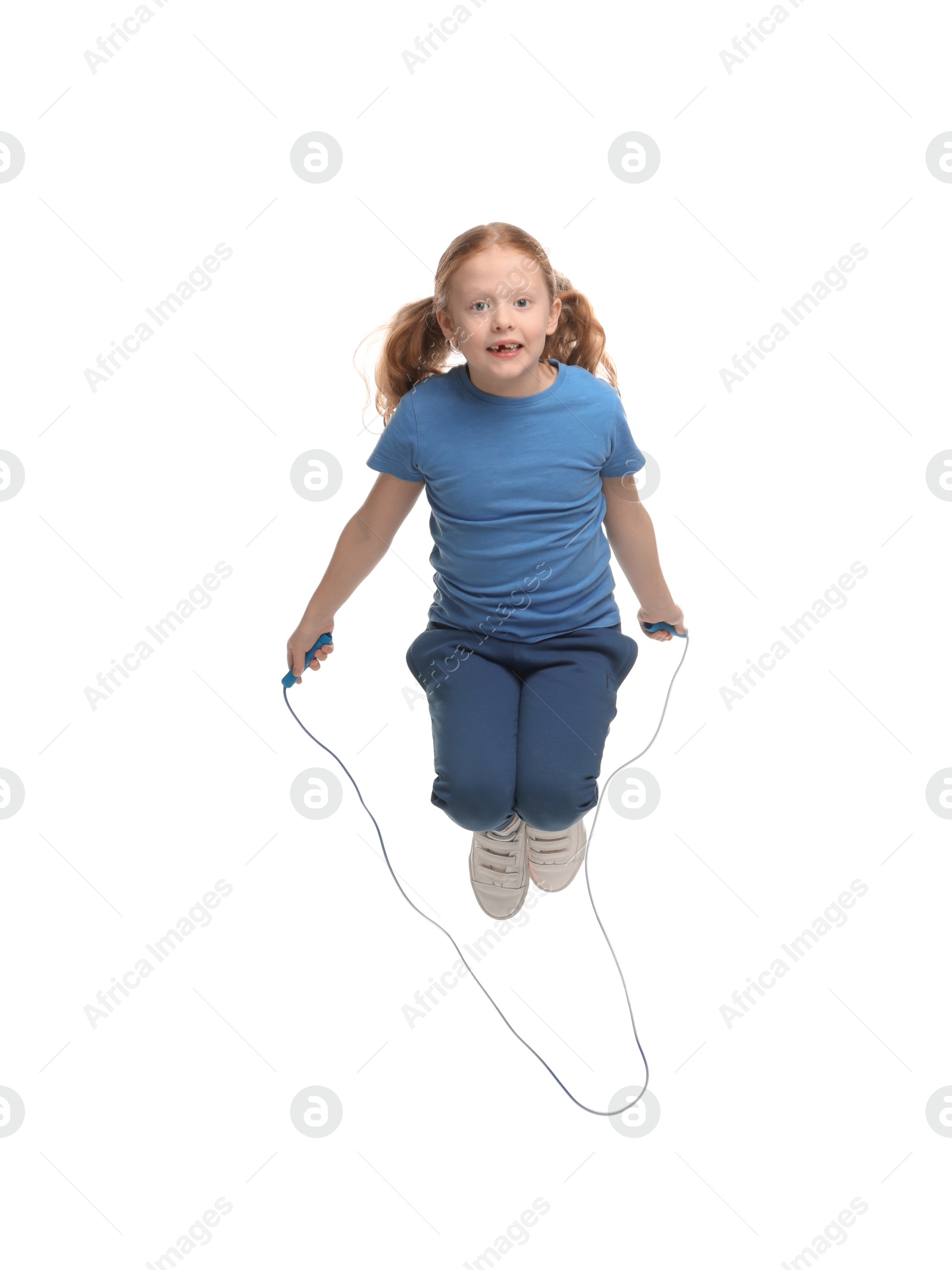 Photo of Cute little girl with skipping rope jumping on white background