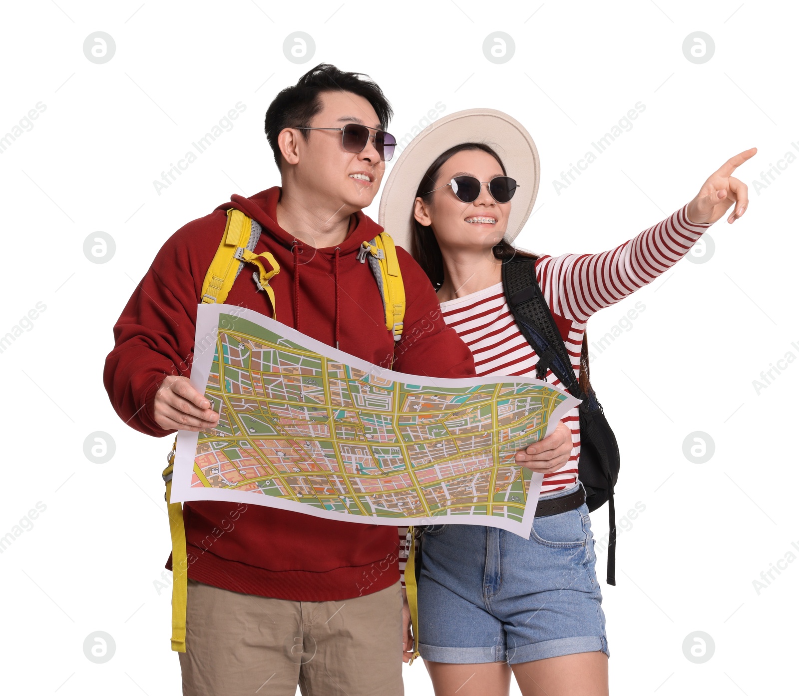 Photo of Happy travellers with map pointing at something on white background