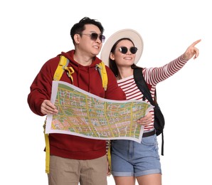 Photo of Happy travellers with map pointing at something on white background