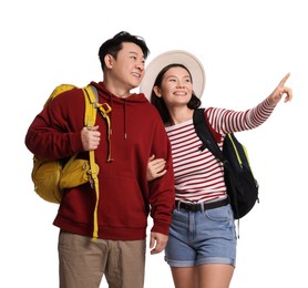 Photo of Happy travellers pointing at something on white background