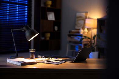 Workspace with laptop on wooden desk in home office