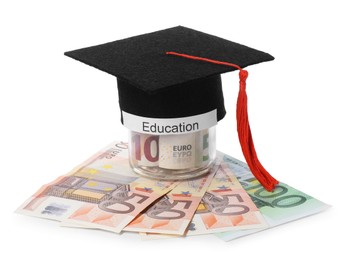 Photo of Graduate hat, euro banknotes and glass jar with word Education isolated on white. Tuition payment