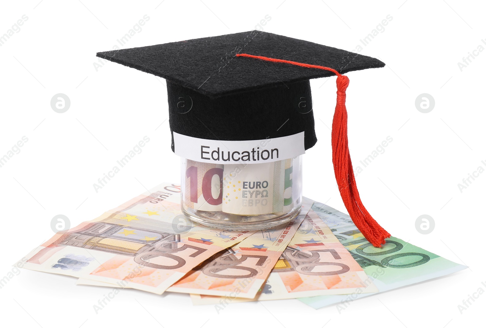 Photo of Graduate hat, euro banknotes and glass jar with word Education isolated on white. Tuition payment