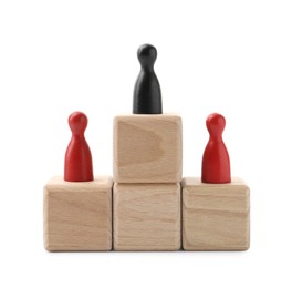 Photo of Red human figures on wooden blocks, black one on top against white background. Competition concept