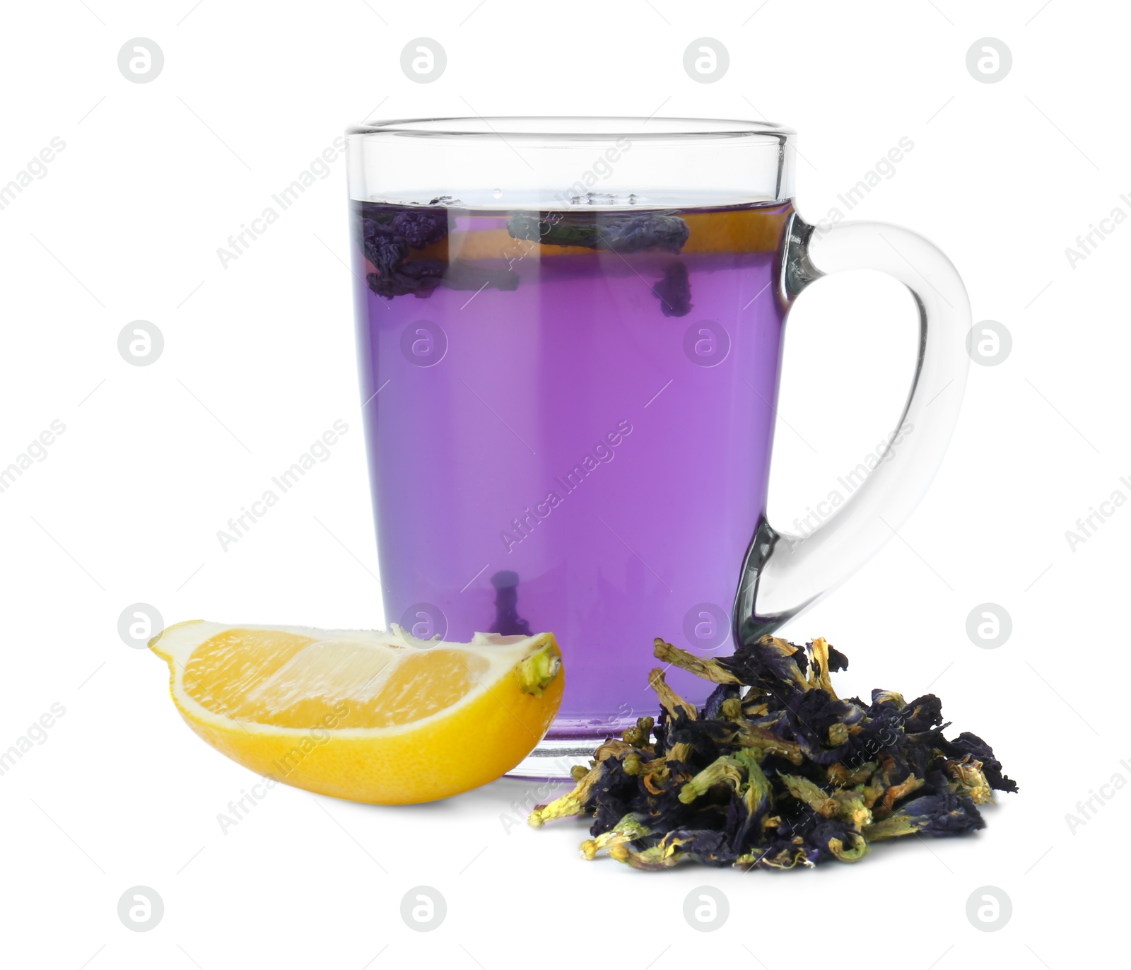 Photo of Delicious butterfly pea flower tea in glass mug, lemon and dry petals isolated on white