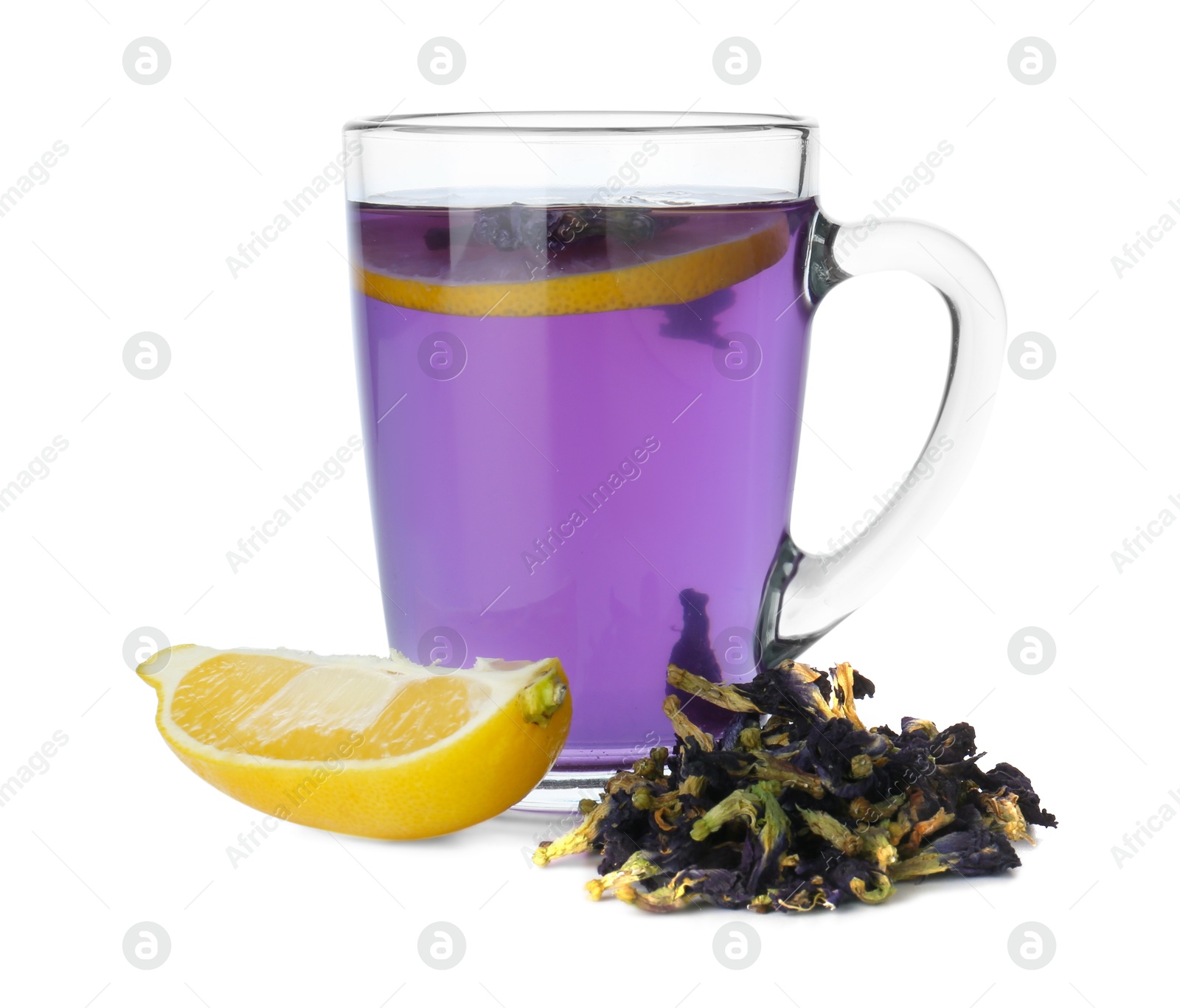 Photo of Delicious butterfly pea flower tea in glass mug, lemon and dry petals isolated on white