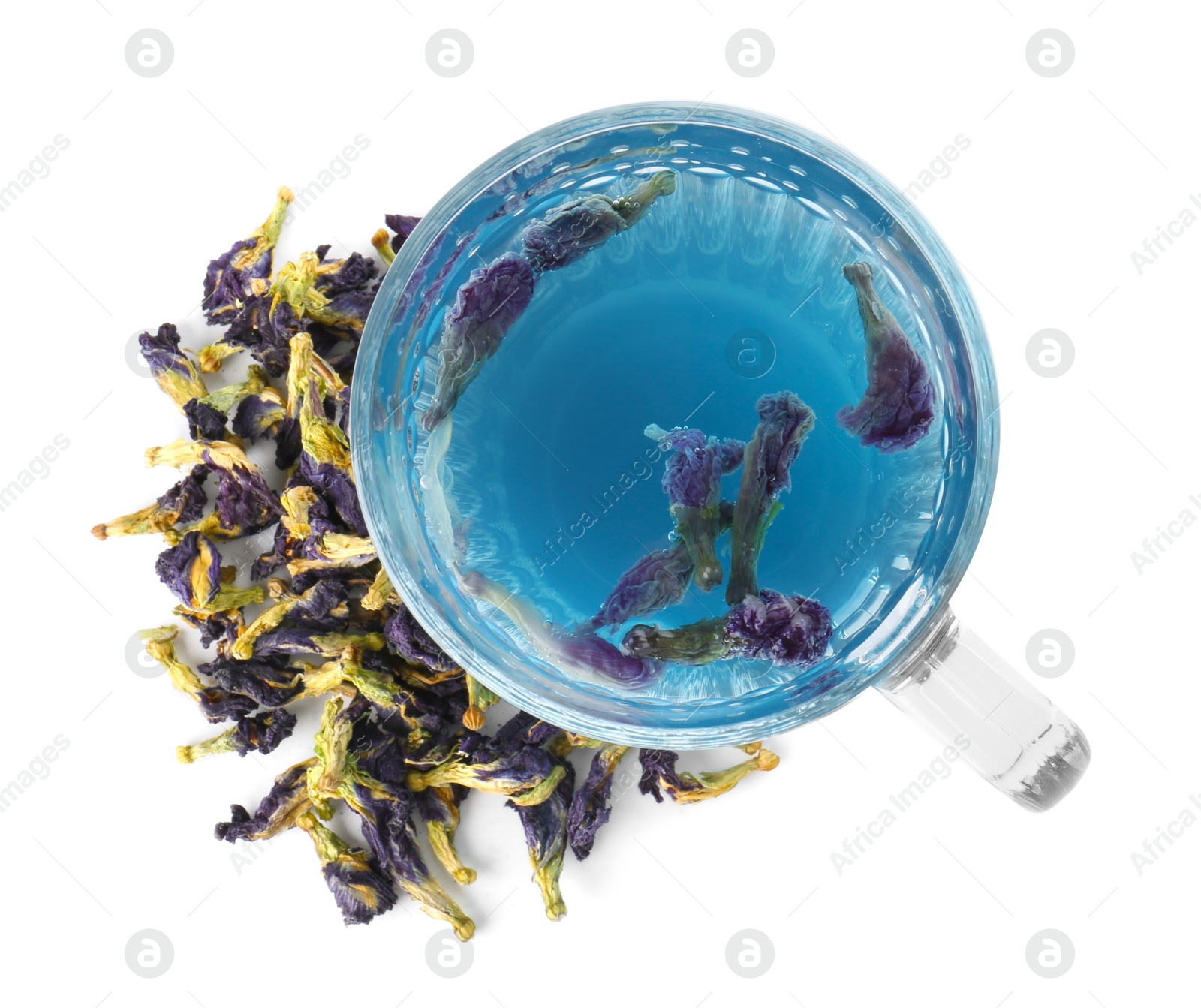 Photo of Delicious butterfly pea flower tea in glass mug and dry petals isolated on white, top view