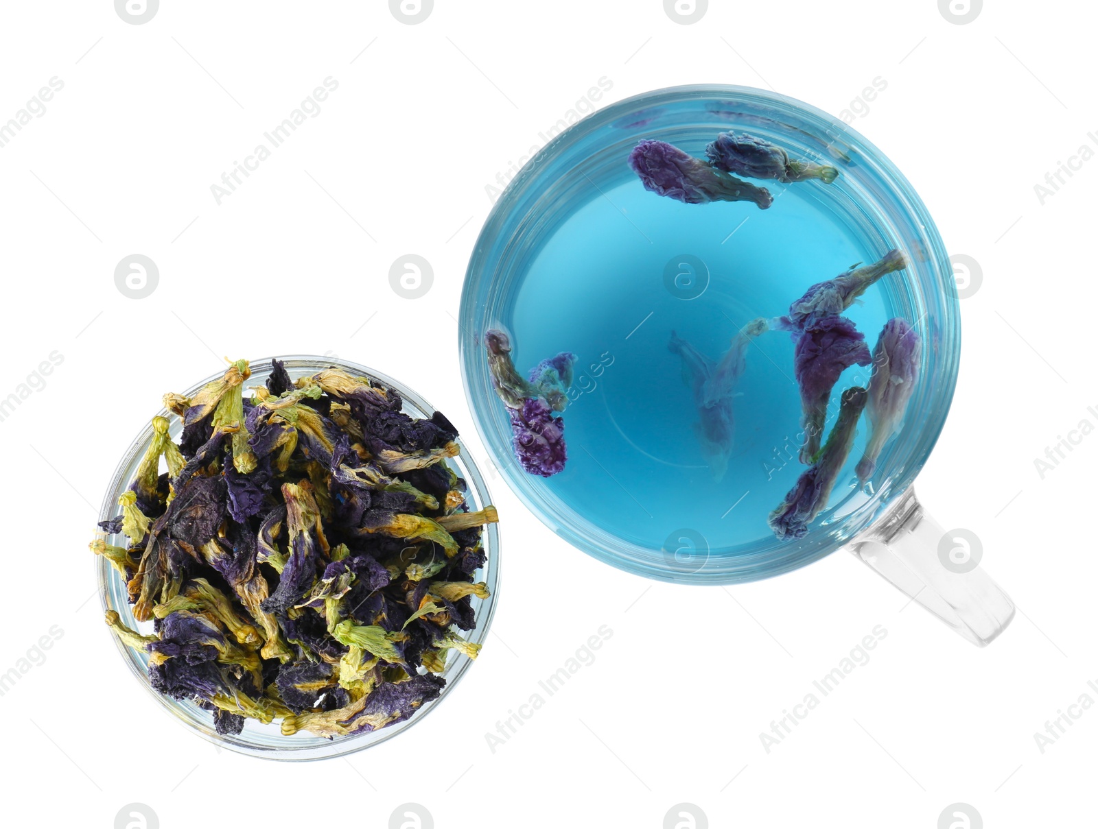 Photo of Delicious butterfly pea flower tea in glass cup and dry petals isolated on white, top view