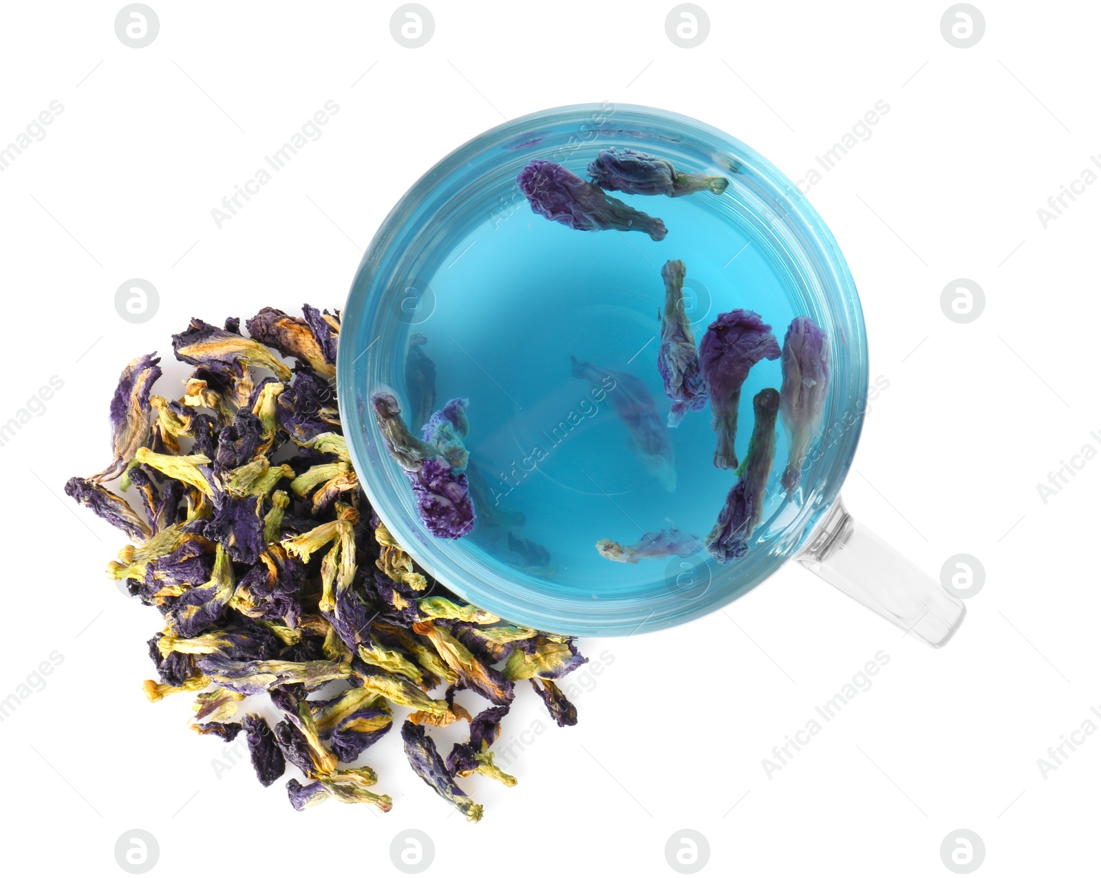 Photo of Delicious butterfly pea flower tea in glass cup and dry petals isolated on white, top view