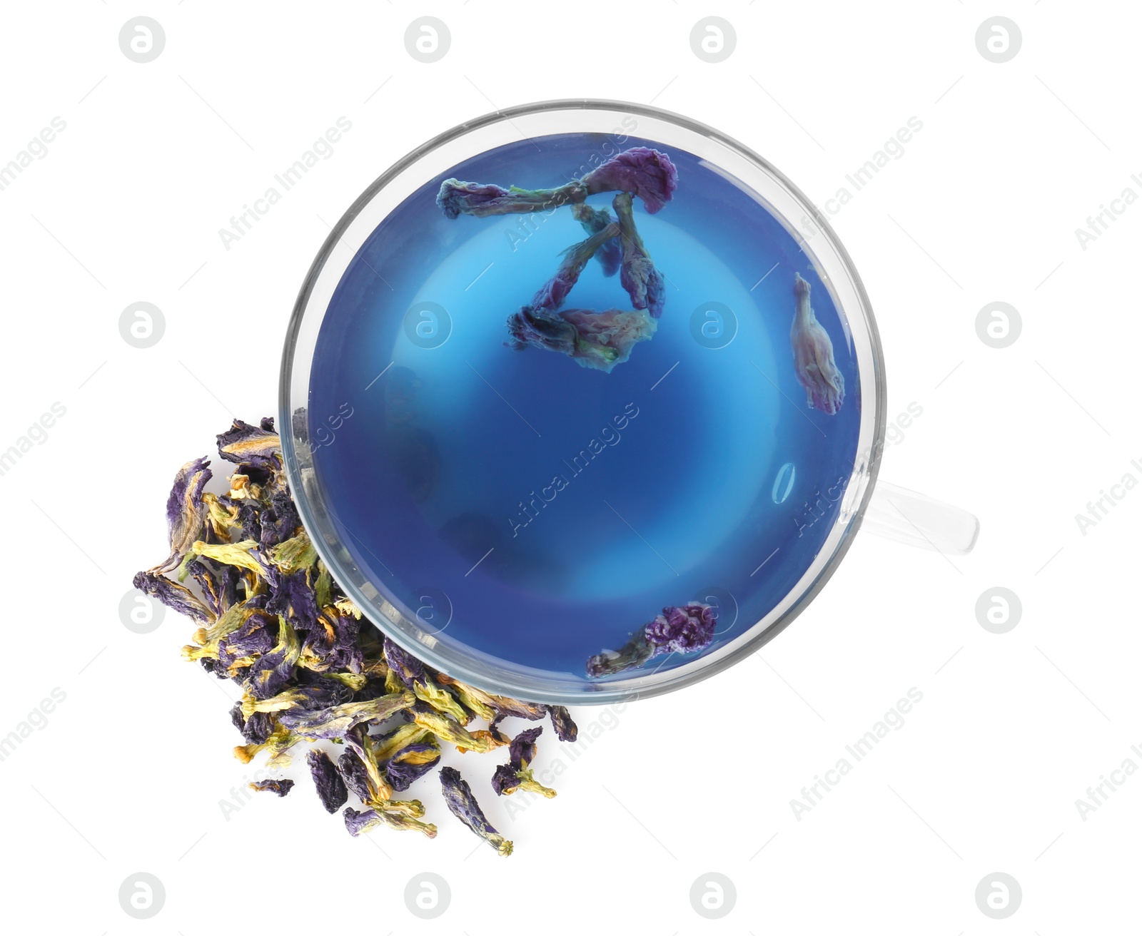 Photo of Delicious butterfly pea flower tea in glass cup and dry petals isolated on white, top view