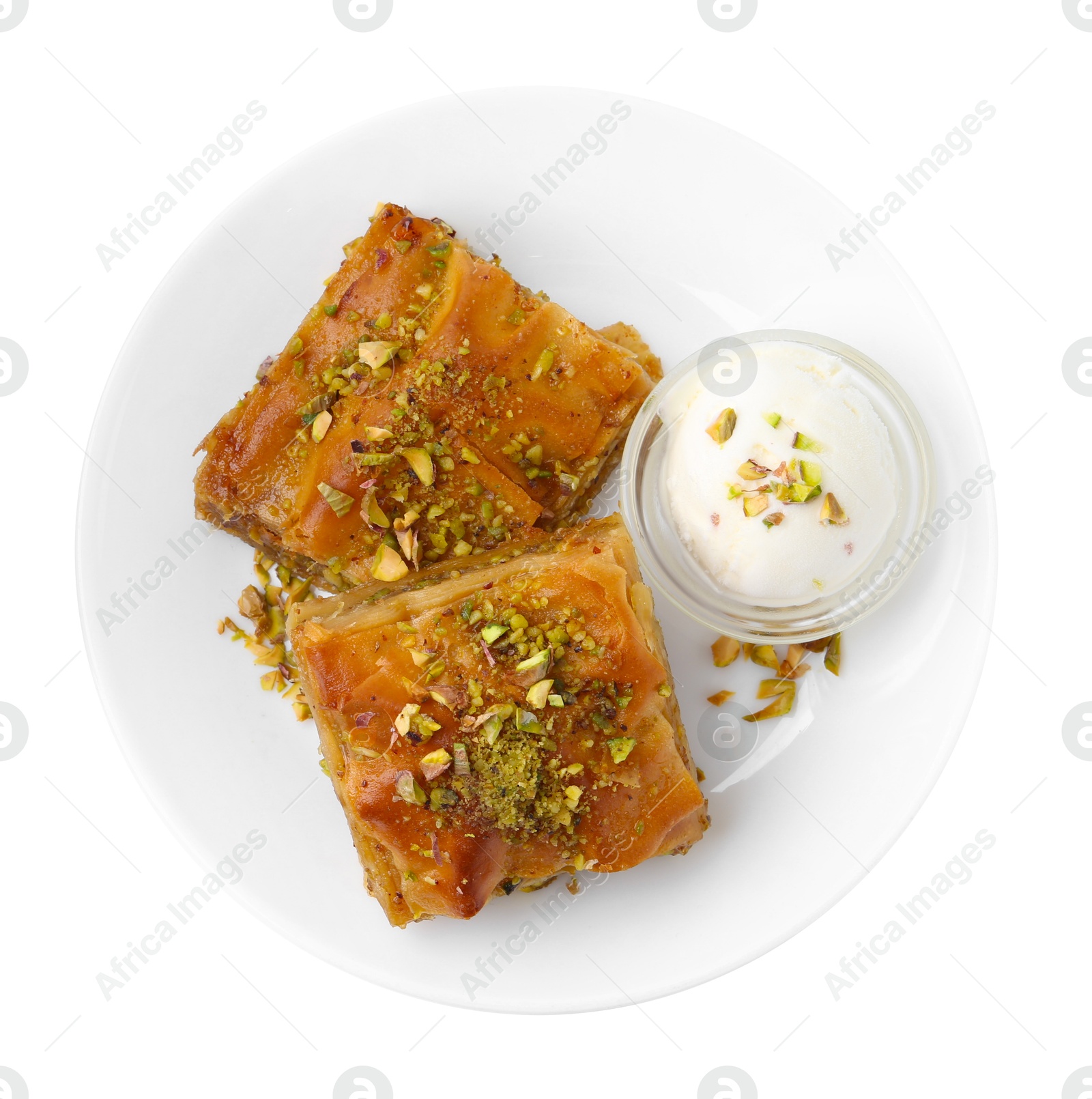 Photo of Tasty baklava with chopped nuts and scoop of ice cream isolated on white, top view