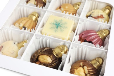 Photo of Box with delicious chocolate in shape of Christmas ornaments, closeup