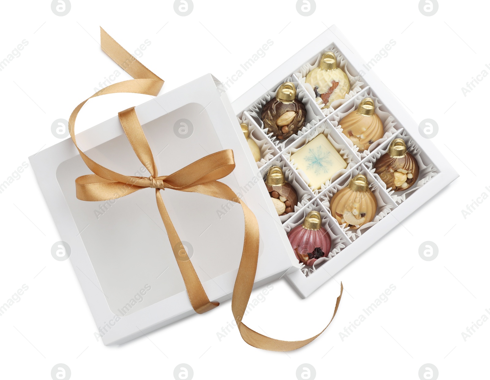 Photo of Open box with delicious chocolate in shape of Christmas ornaments isolated on white, top view