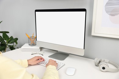 Photo of Comfortable workplace with modern computer on white table indoors