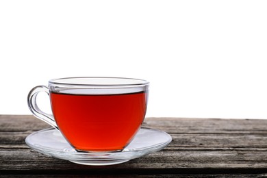 Photo of Refreshing black tea in cup on wooden table against white background