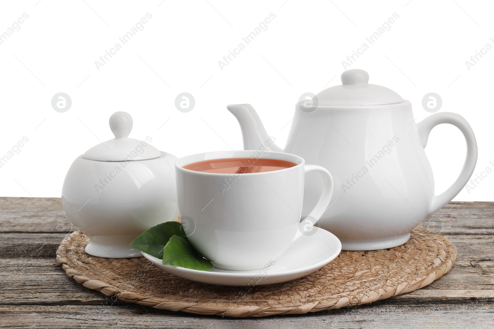 Photo of Refreshing black tea and sugar on wooden table against white background