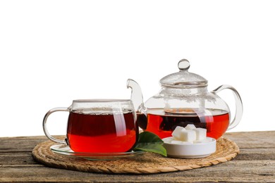 Photo of Refreshing black tea and sugar on wooden table against white background