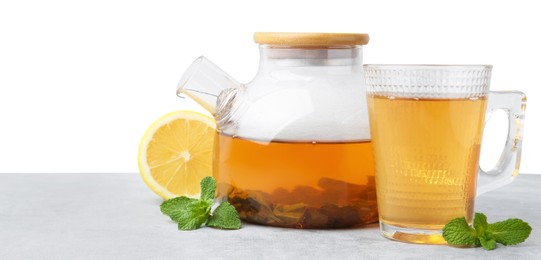 Photo of Aromatic mint tea, fresh leaves and lemon on light gray table against white background, space for text